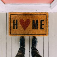 Welcome matt reads Home with a heart in place of the letter O