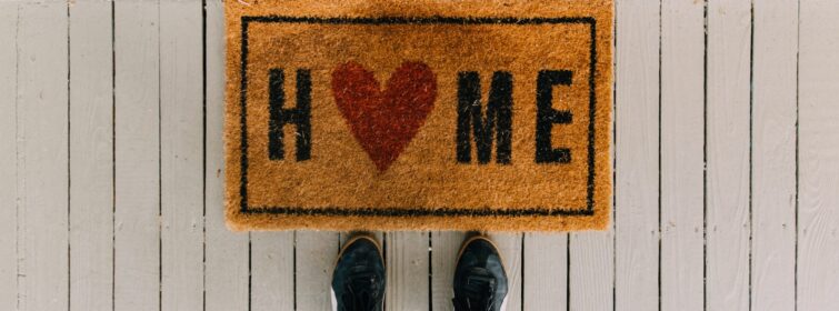 Welcome matt reads Home with a heart in place of the letter O